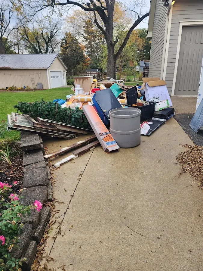 Dumpster being loaded with debris for Roofing Dumpster Rental in Dayton